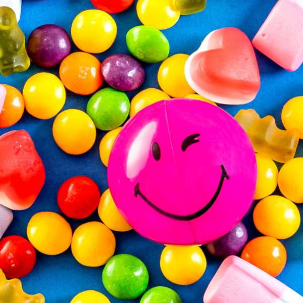 Purple Smiley Halves on a pile of sweets